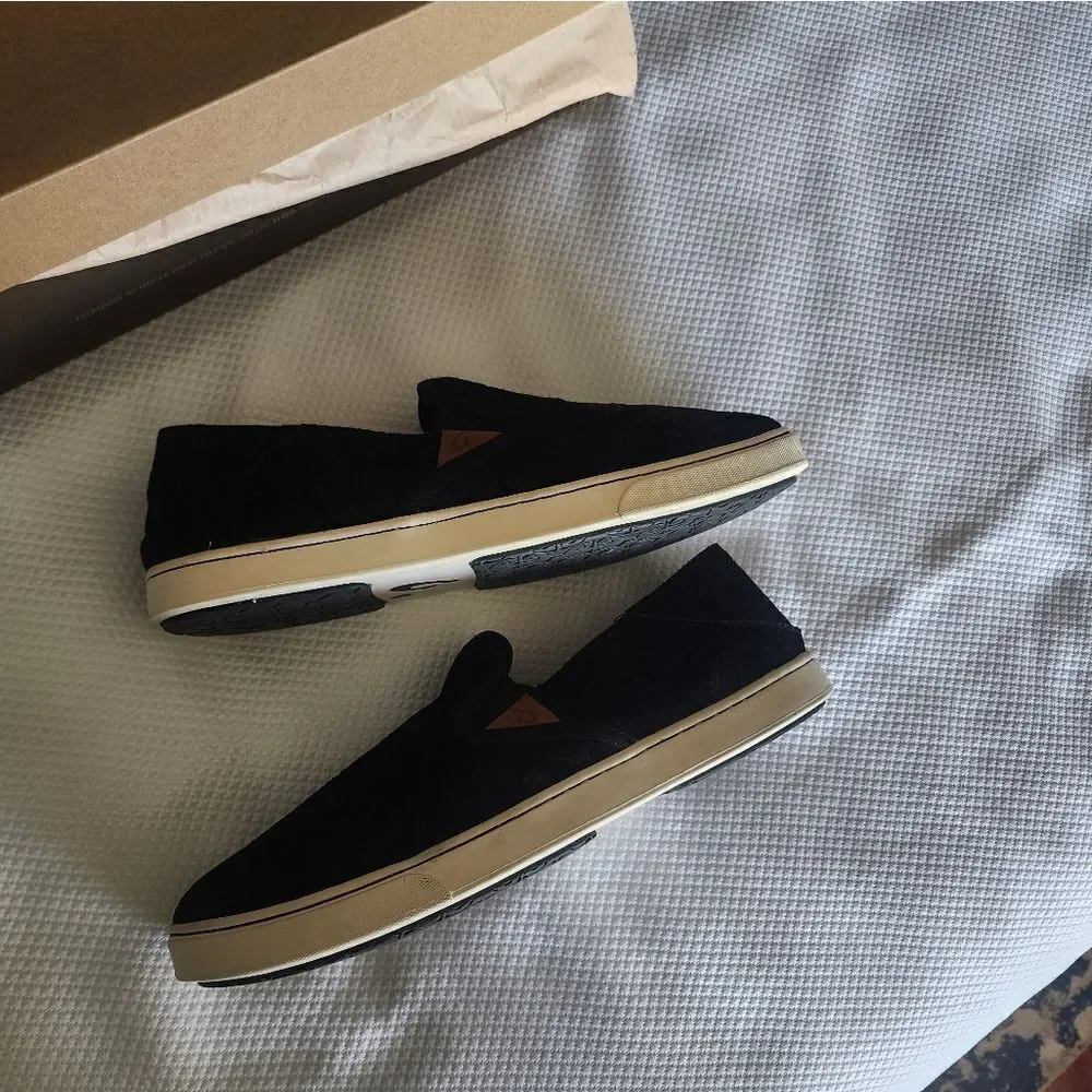 OluKai Black and White Flats Sleek Slip-On Design